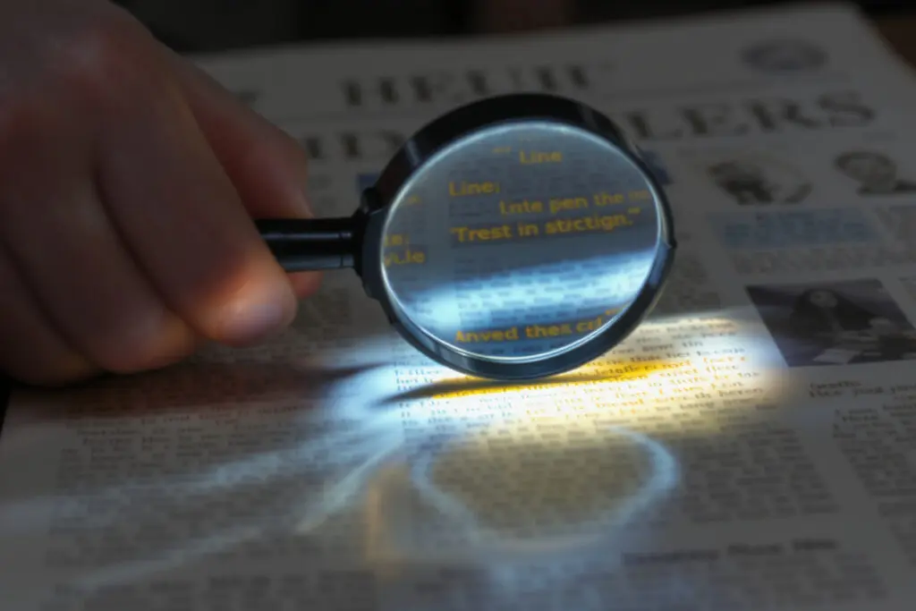 A magnifying glass drawing attention to a single line of text symbolizing how to write meta descriptions for high CTR -  Rank Your Domain | SEO That Converts Clicks to Customers A magnifying glass drawing attention to a single line of text symbolizing how to write meta descriptions for high CTR