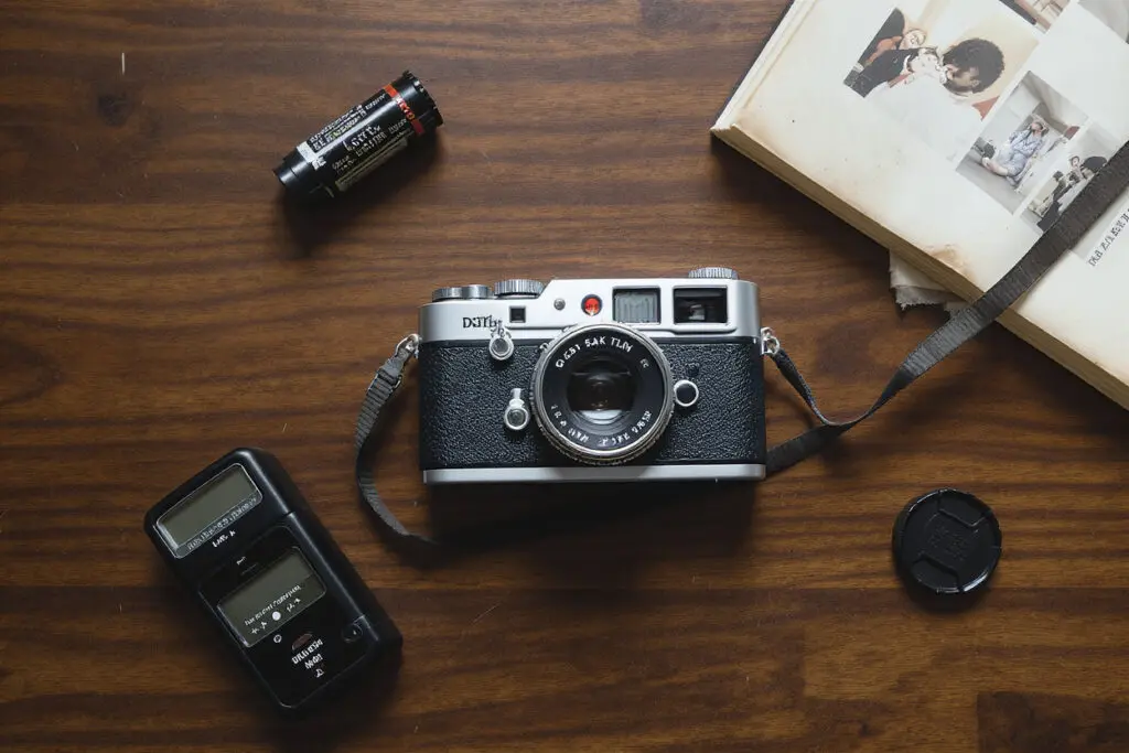 A vintage camera surrounded by related photographic items illustrating how to use LSI keywords in content -  Rank Your Domain | SEO That Converts Clicks to Customers A vintage camera surrounded by related photographic items illustrating how to use LSI keywords in content